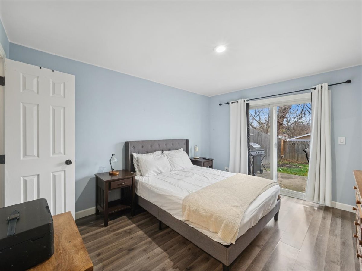 1220 Fulton Drive Streamwood, IL 60107 - Photo 9 of 18 a bedroom with a bed lamp and a large window