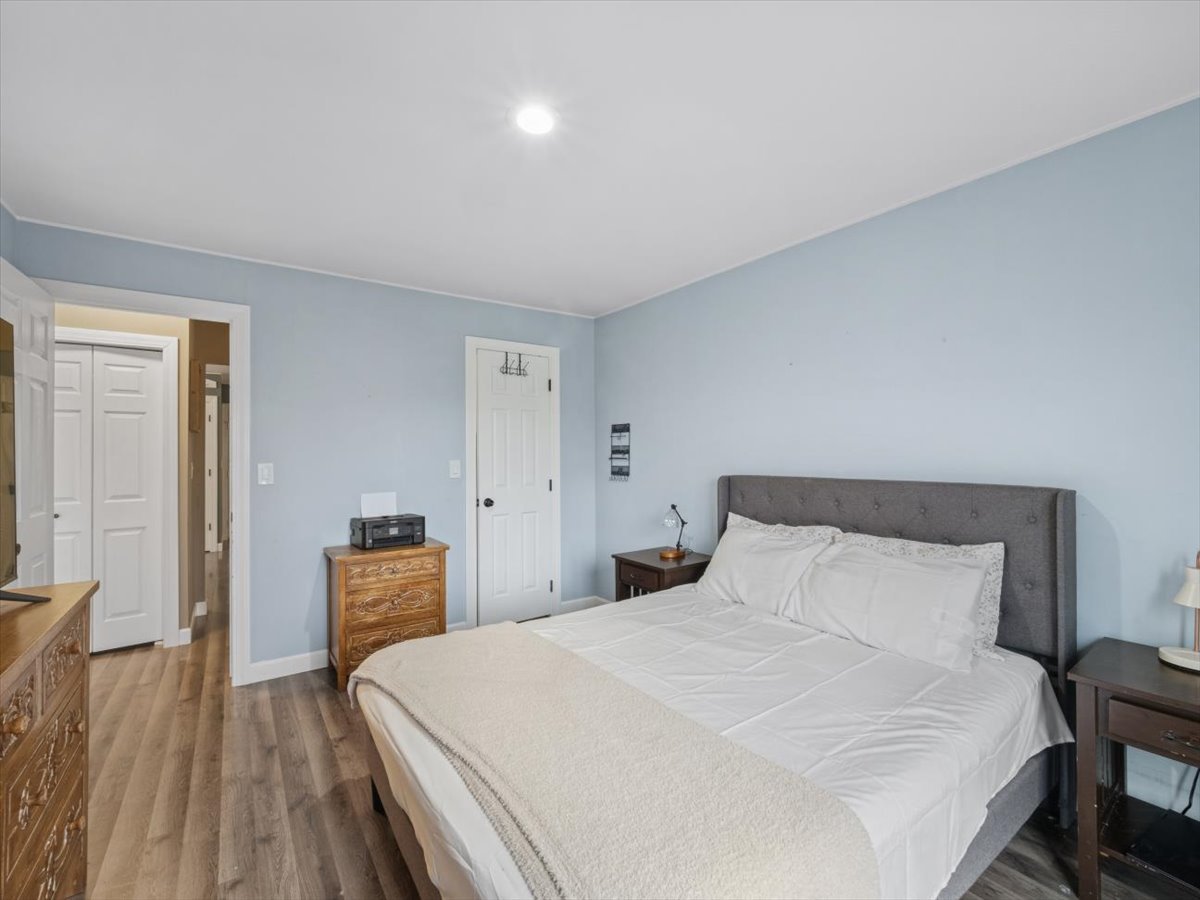 1220 Fulton Drive Streamwood, IL 60107 - Photo 10 of 18 a bedroom with a bed and wooden floor