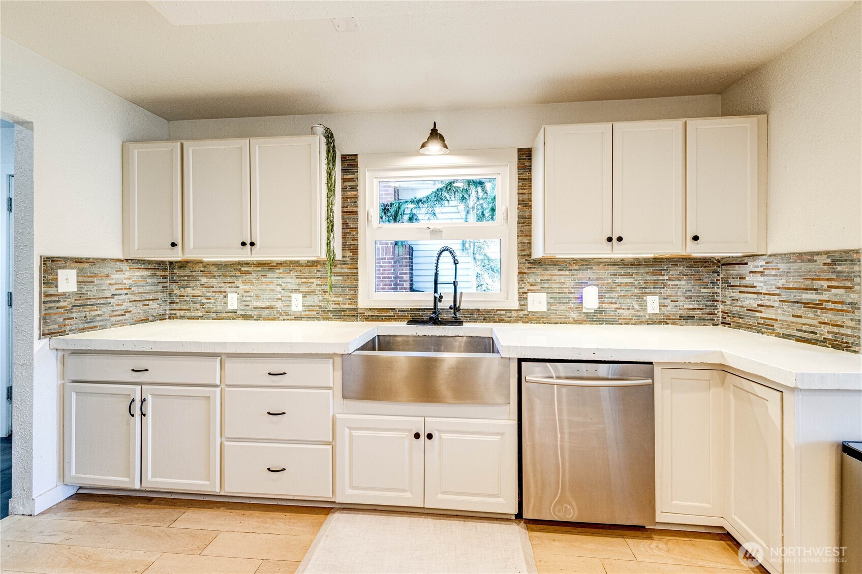 231 West 4th Street Port Angeles, WA 98362 - Photo 14 of 40 a kitchen with granite countertop white cabinets white stainless steel appliances with a sink and dishwasher