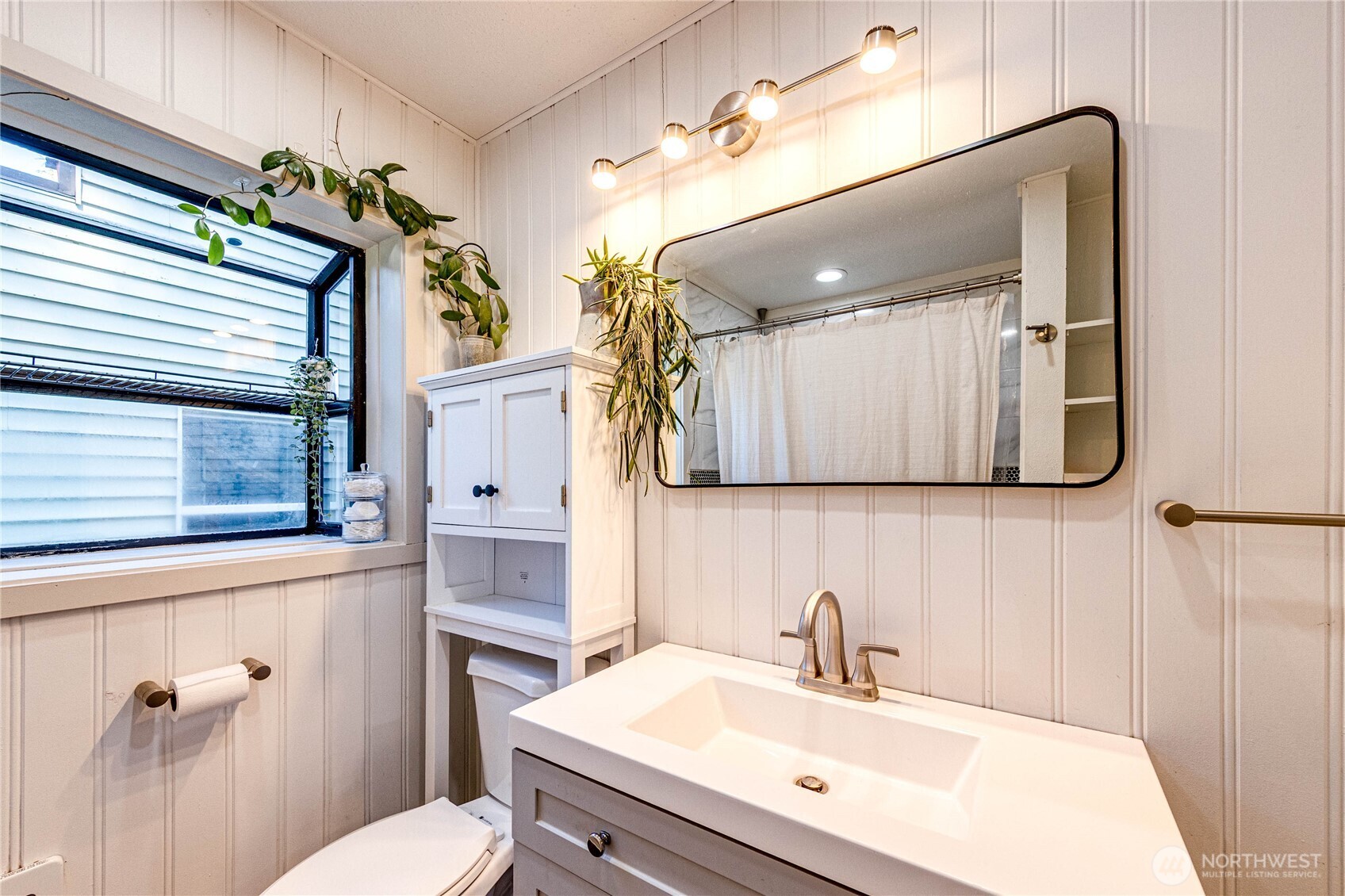 231 West 4th Street Port Angeles, WA 98362 - Photo 24 of 40 a bathroom with a sink a toilet and mirror
