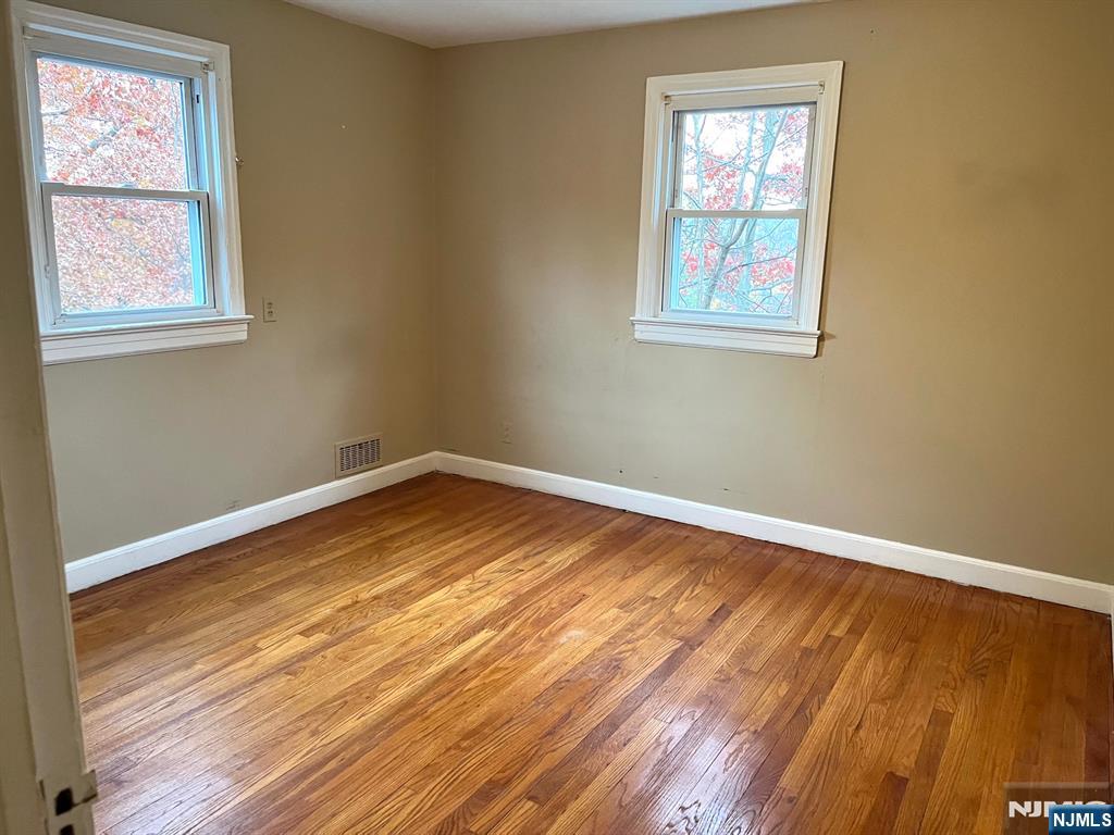 162 Union Place Ridgefield Park, NJ 07660 - Photo 21 of 21 a view of empty room with wooden floor and fan