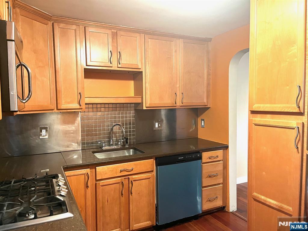 162 Union Place Ridgefield Park, NJ 07660 - Photo 3 of 21 a kitchen with granite countertop a sink and a stove next to a window