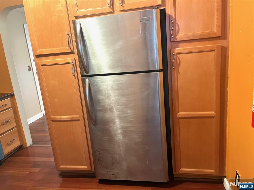 162 Union Place Ridgefield Park, NJ 07660 - Photo 4 of 21 a view of a refrigerator in kitchen and an empty room with wooden floor