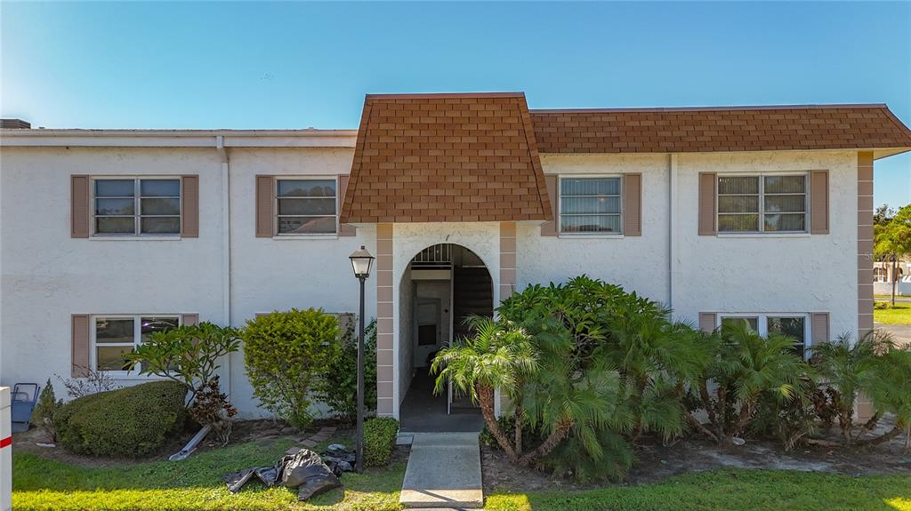 379 South McMullen Booth Road, Unit 76 Clearwater, FL 33759 - Photo 1 of 39 a front view of a house with yard and garage