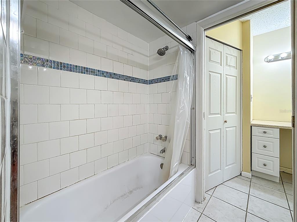 379 South McMullen Booth Road, Unit 76 Clearwater, FL 33759 - Photo 21 of 39 a bathroom with a bathtub and a shower