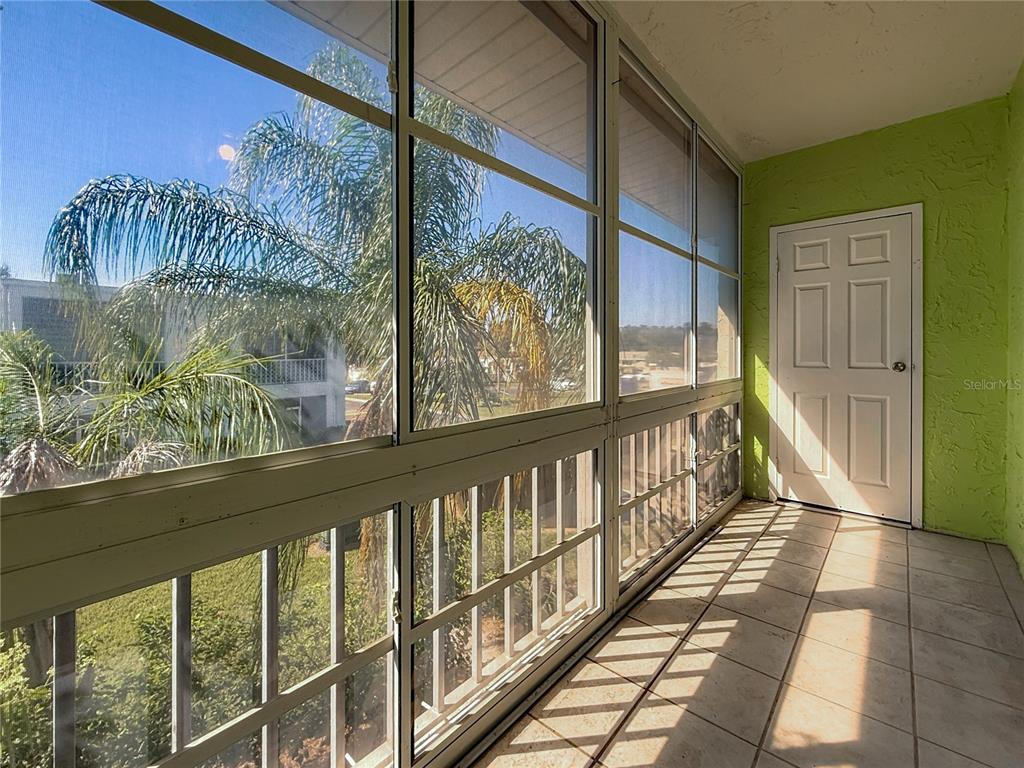379 South McMullen Booth Road, Unit 76 Clearwater, FL 33759 - Photo 26 of 39 a view of a balcony with wooden floor