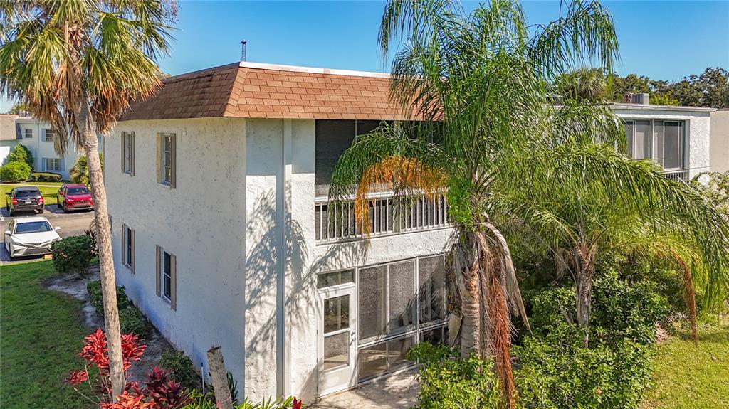 379 South McMullen Booth Road, Unit 76 Clearwater, FL 33759 - Photo 31 of 39 a view of a house with a tree next to a yard