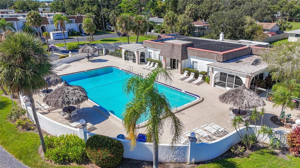 379 South McMullen Booth Road, Unit 76 Clearwater, FL 33759 - Photo 37 of 39 a view of multiple houses with a yard and potted plants
