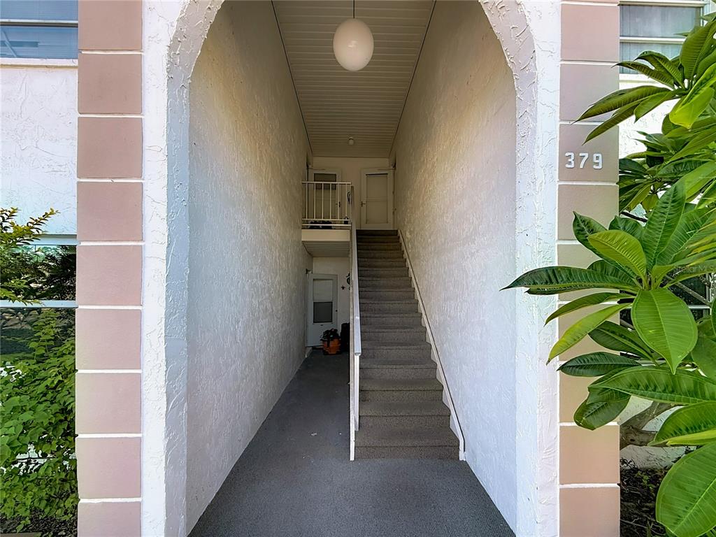 379 South McMullen Booth Road, Unit 76 Clearwater, FL 33759 - Photo 39 of 39 a view of a hallway with potted plants