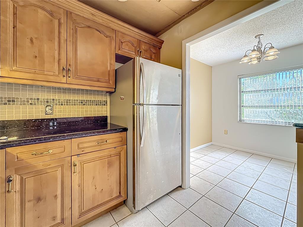 379 South McMullen Booth Road, Unit 76 Clearwater, FL 33759 - Photo 6 of 39 a white refrigerator freezer sitting inside of a kitchen