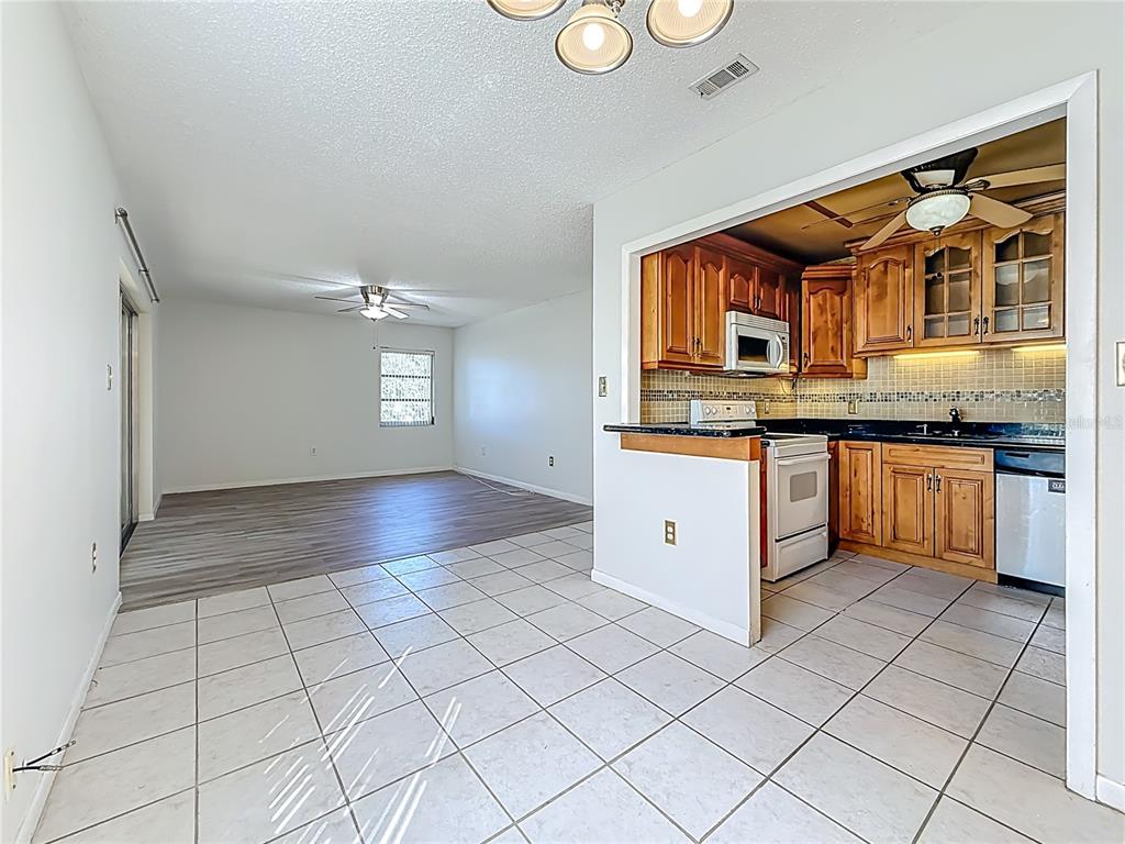 379 South McMullen Booth Road, Unit 76 Clearwater, FL 33759 - Photo 8 of 39 a kitchen with stainless steel appliances granite countertop a sink and cabinets
