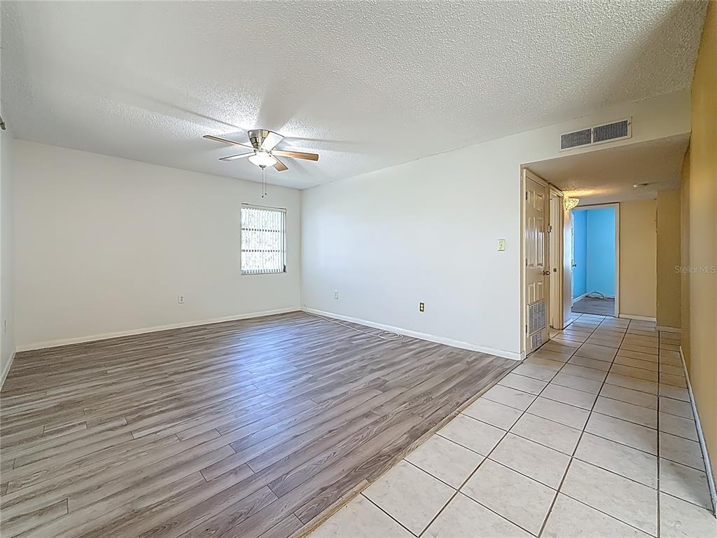 379 South McMullen Booth Road, Unit 76 Clearwater, FL 33759 - Photo 10 of 39 wooden floor in an empty room with a window