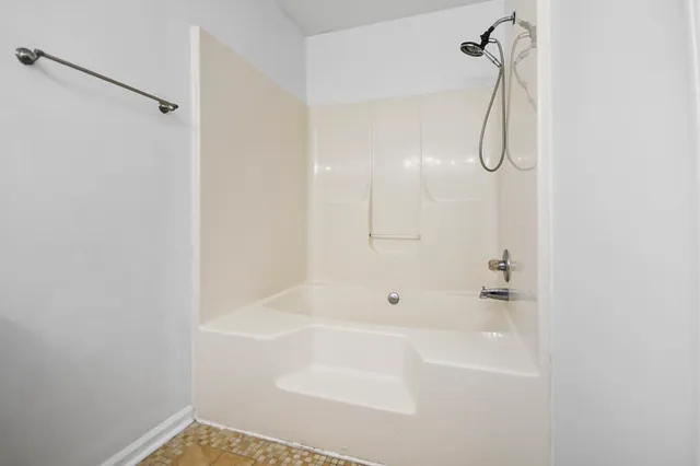 a bathroom with a shower and a shower