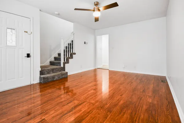 a view of an empty room with wooden floor