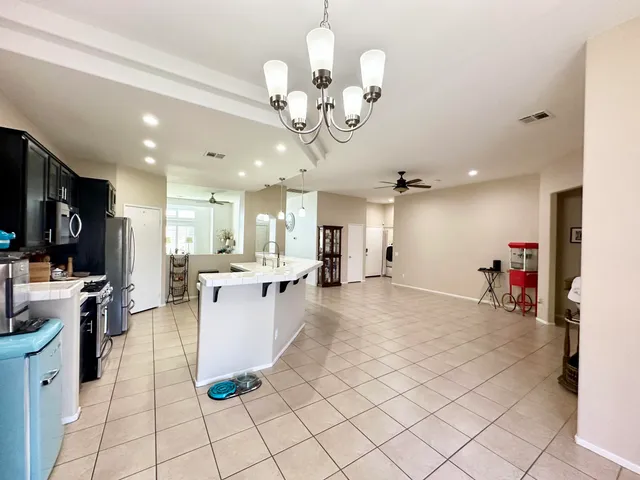 a large kitchen with stainless steel appliances lots of counter top space