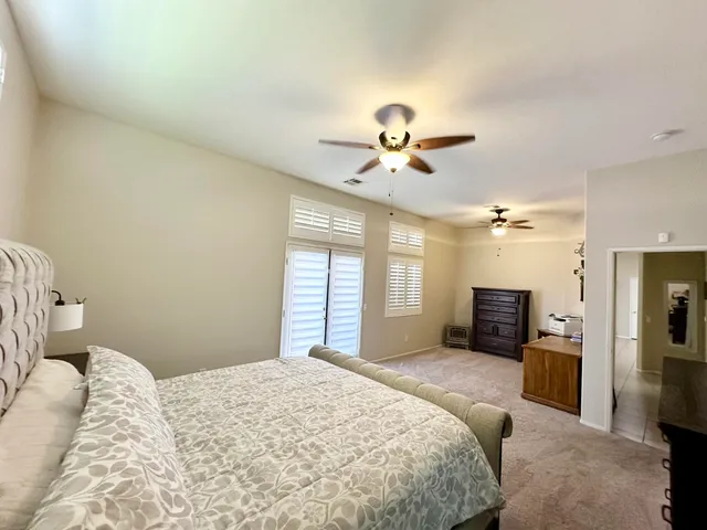 a bedroom with a large bed and a chandelier