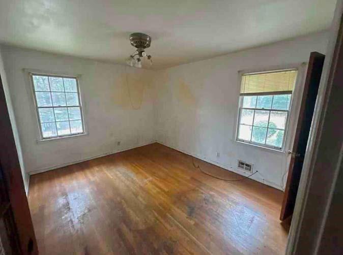 4628 Tucson Trail Southwest Atlanta, GA 30331 - Photo 25 of 29 an empty room with wooden floor and windows