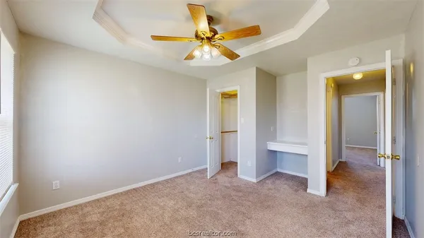 an empty room and chandelier fan