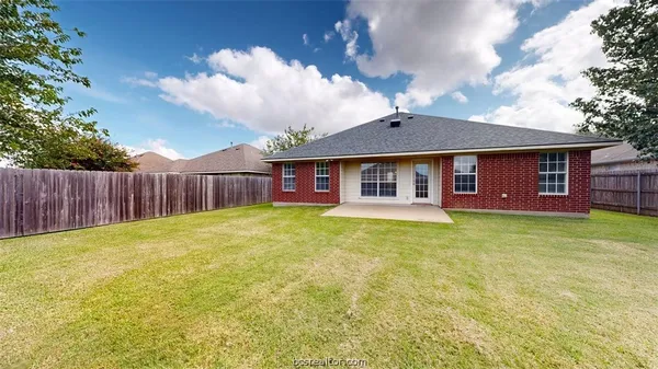 a view of a house with a backyard