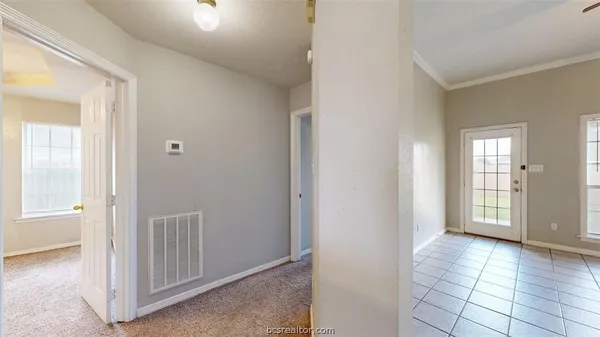 an empty room with windows and closet