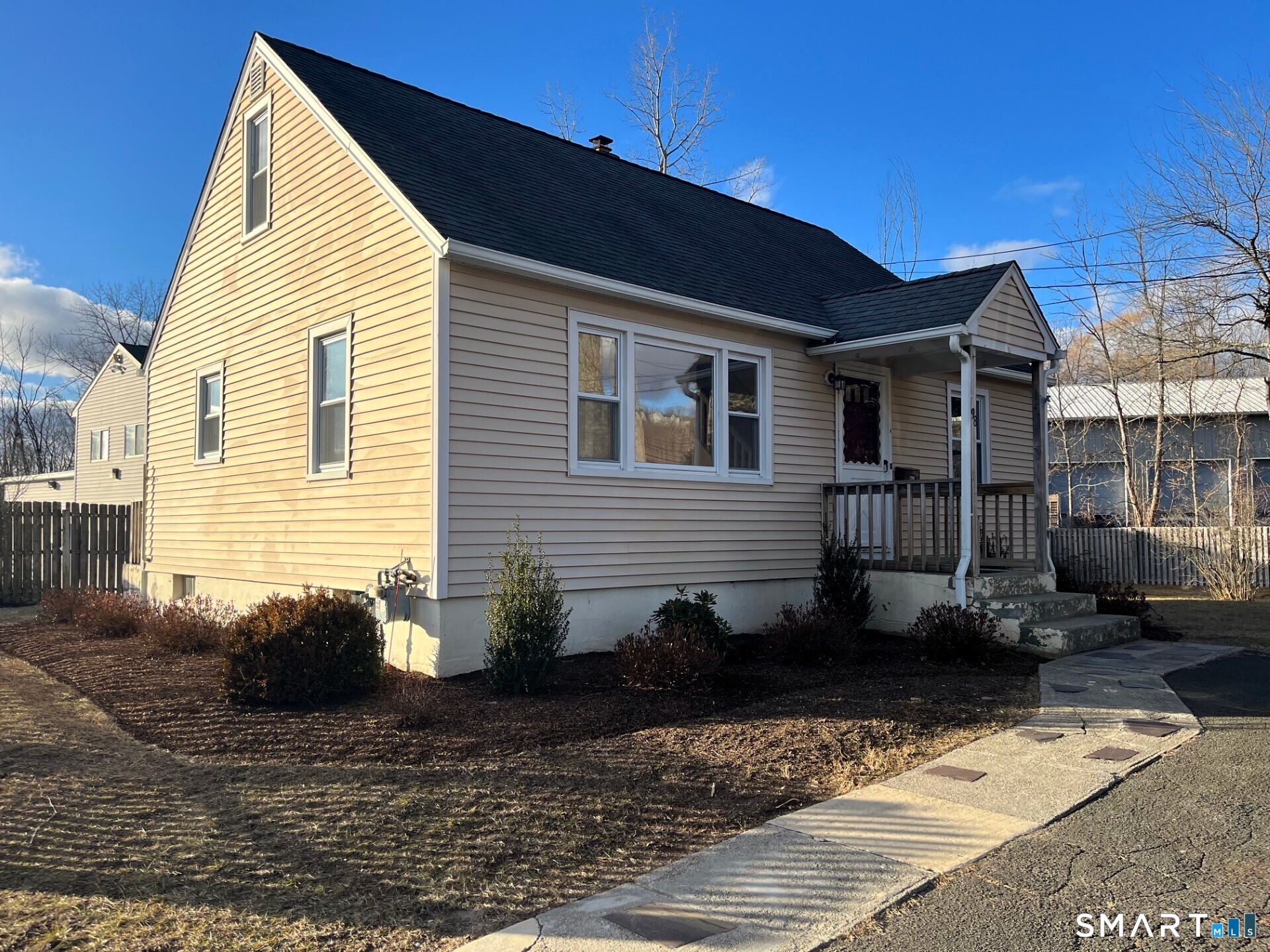 a backyard of a house with potted plants