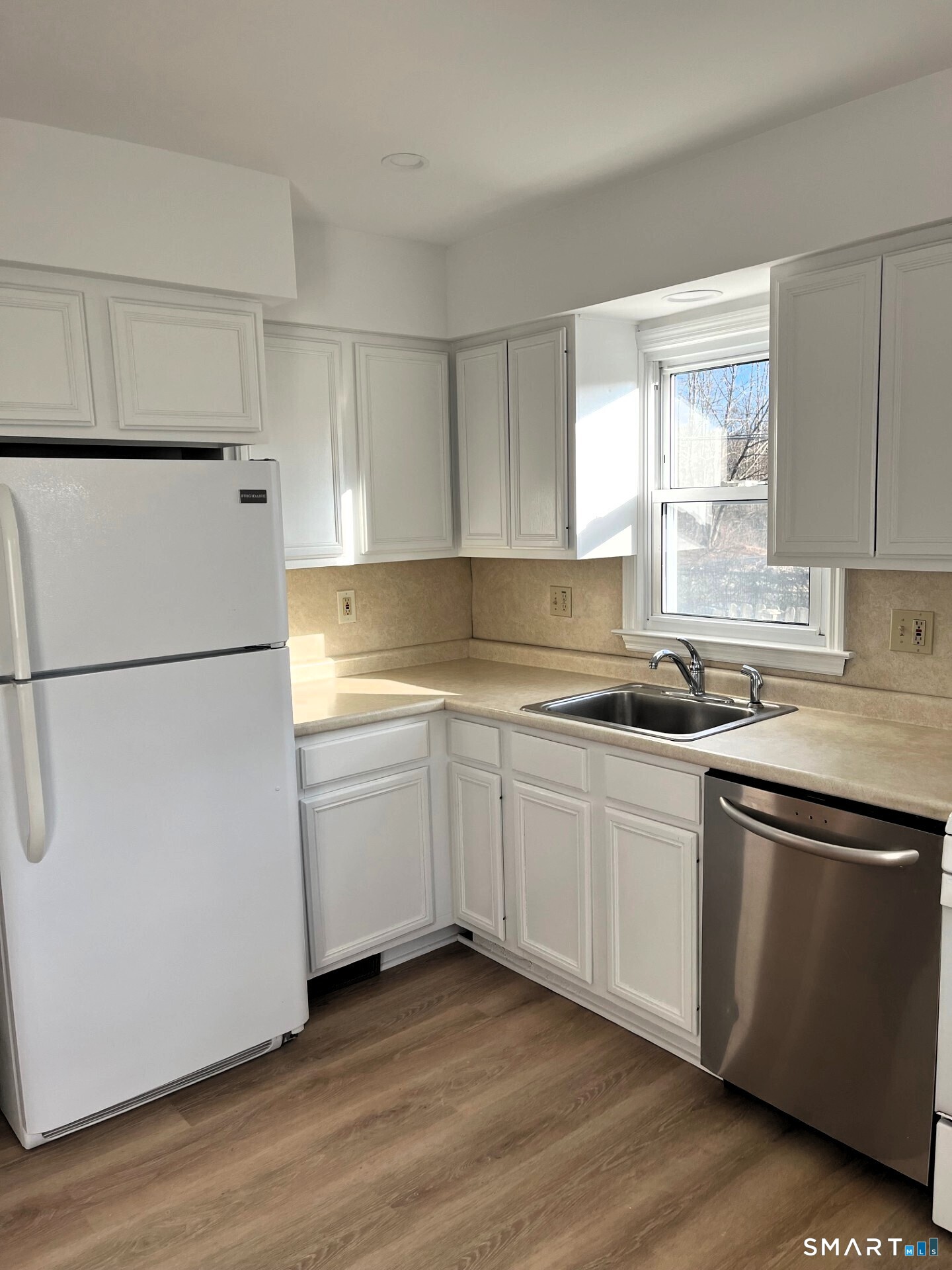 98 Wooster Street Bethel, CT 06801 - Photo 5 of 17 a kitchen with granite countertop white cabinets and white appliances