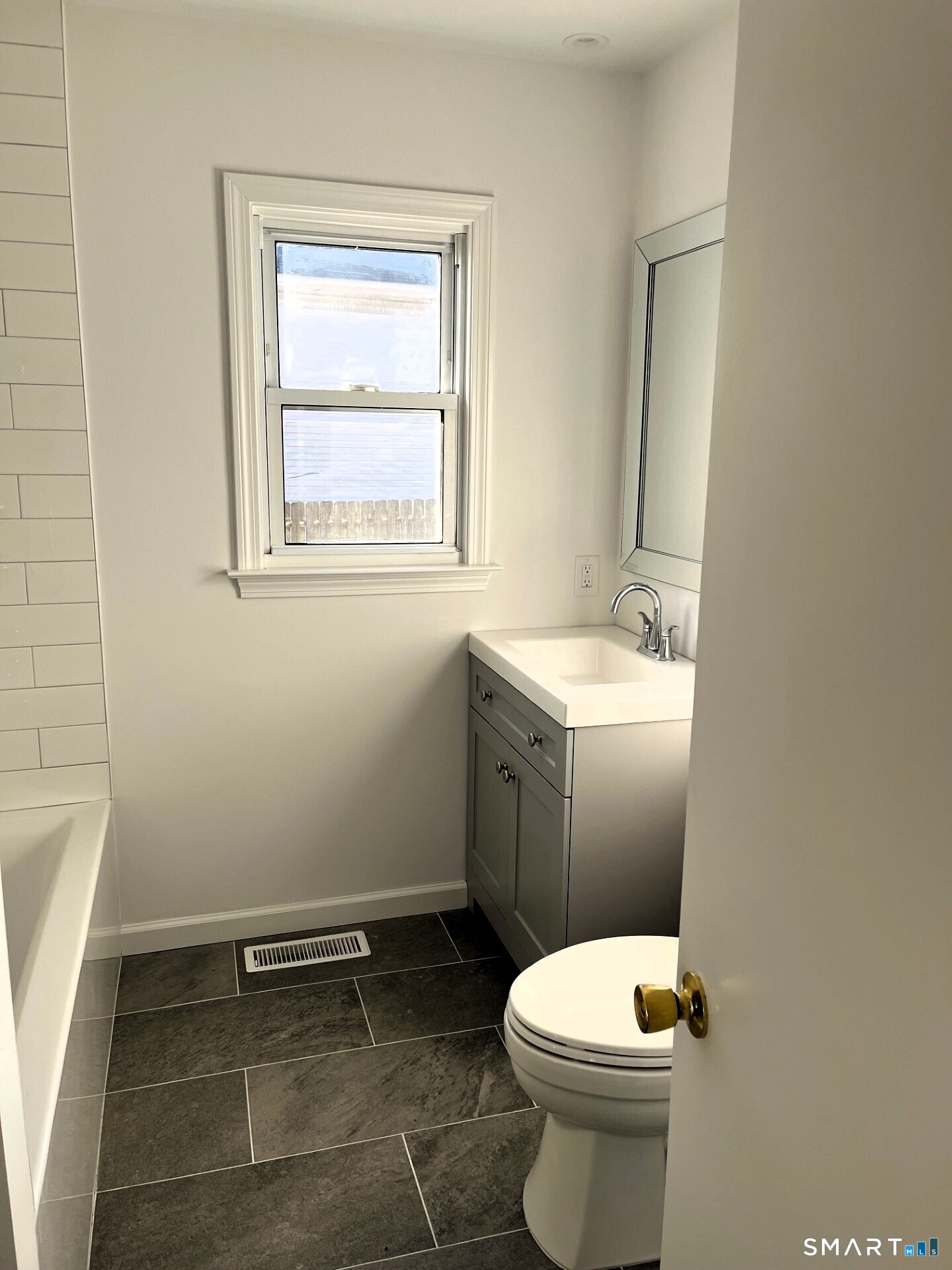 98 Wooster Street Bethel, CT 06801 - Photo 6 of 17 a bathroom with a toilet sink and mirror