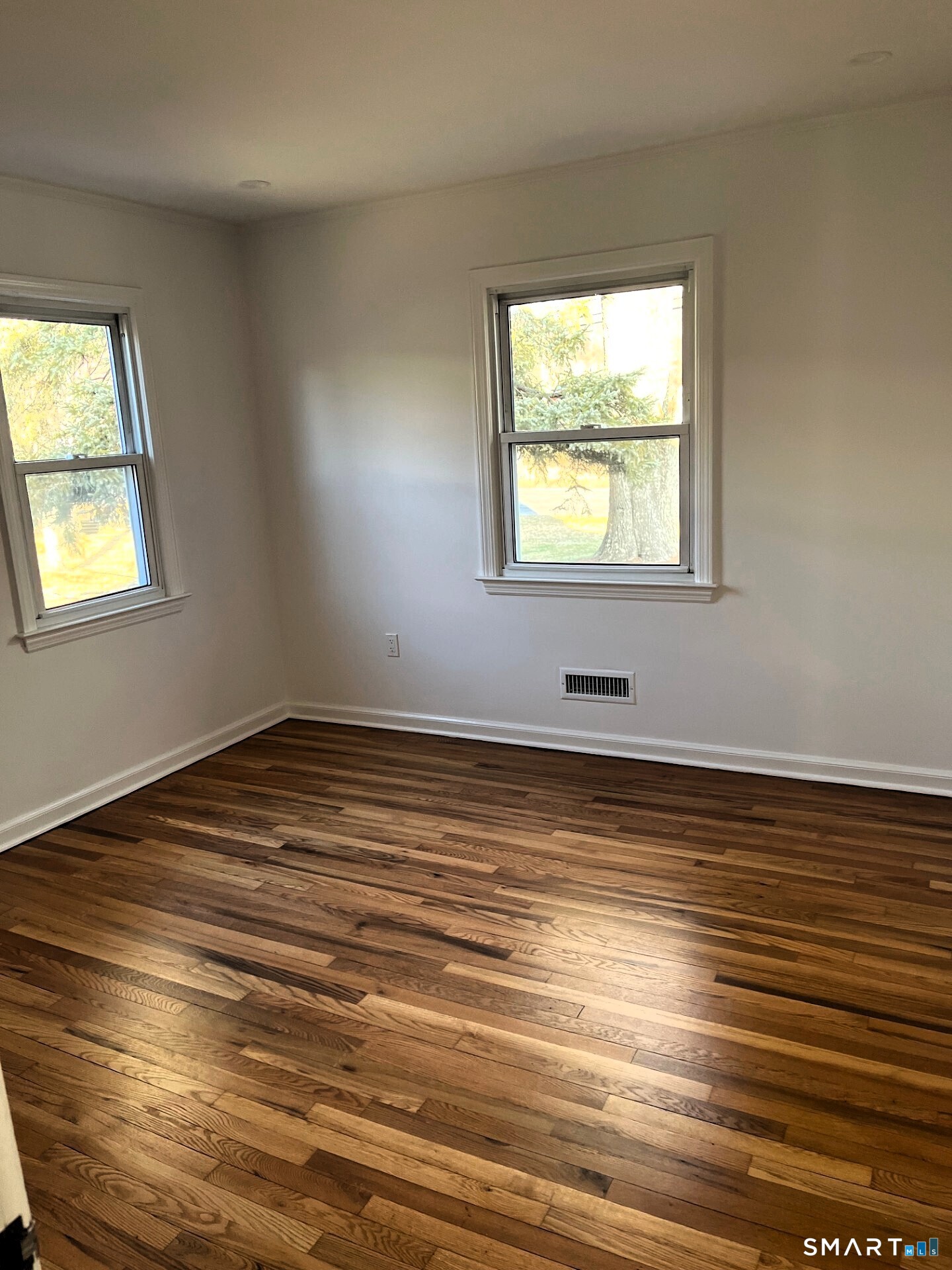 98 Wooster Street Bethel, CT 06801 - Photo 9 of 17 an empty room with wooden floor and windows