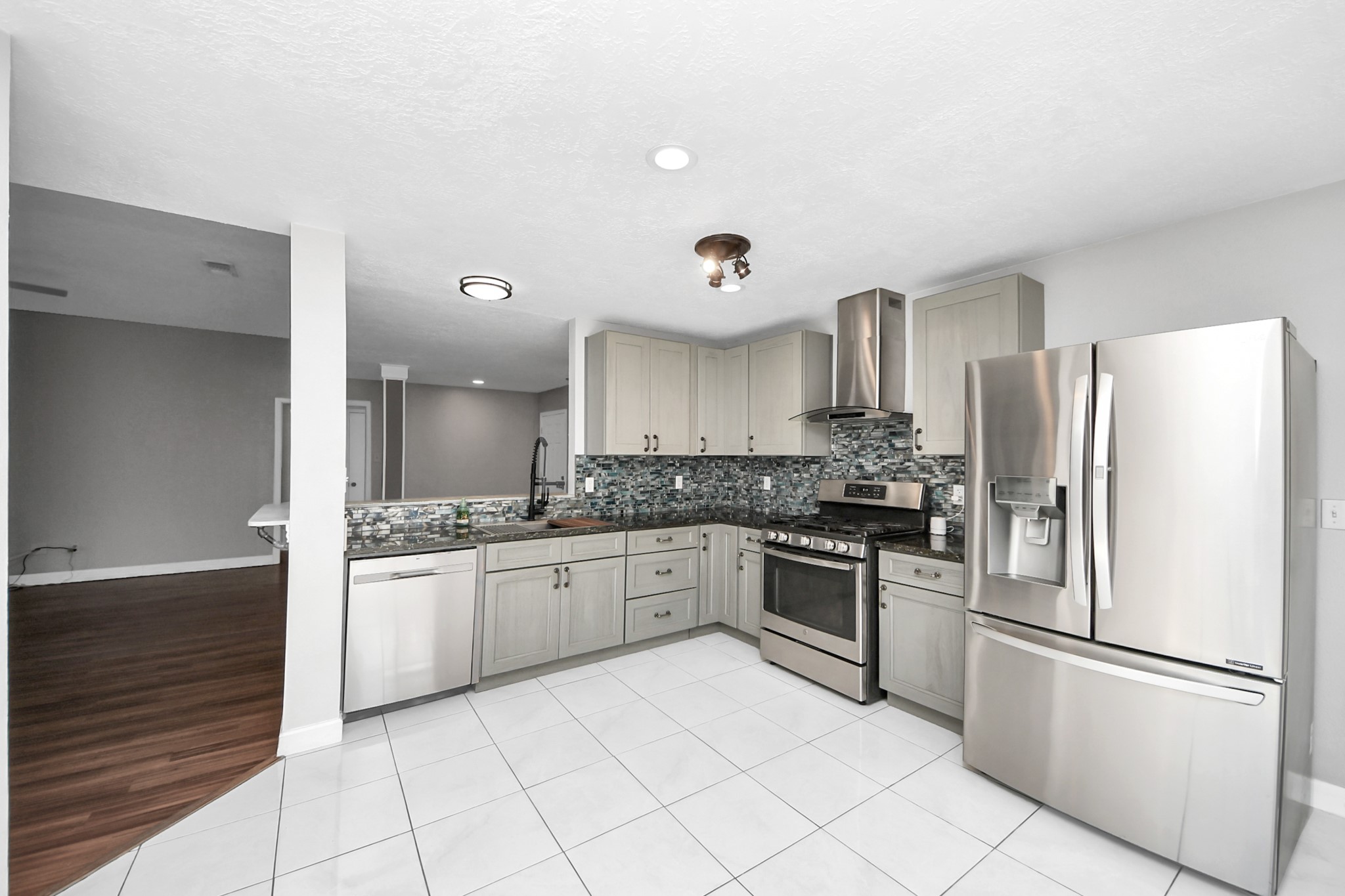 28707 Stapleford Street Spring, TX 77386 - Photo 12 of 38 a kitchen with stainless steel appliances granite countertop a refrigerator and a stove top oven