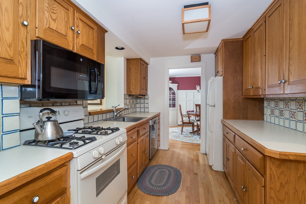 77 Parker Road Wellesley, MA 02482 - Photo 12 of 19 a kitchen with stainless steel appliances a stove a sink and a microwave