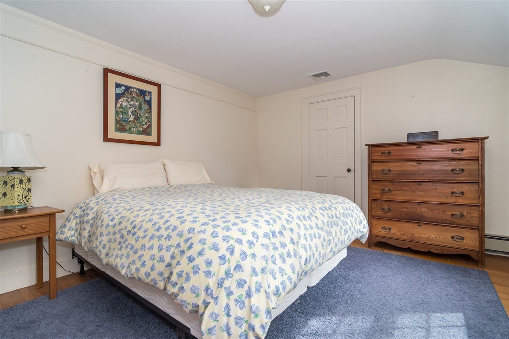 77 Parker Road Wellesley, MA 02482 - Photo 16 of 19 a bedroom with a bed and painting on the wall