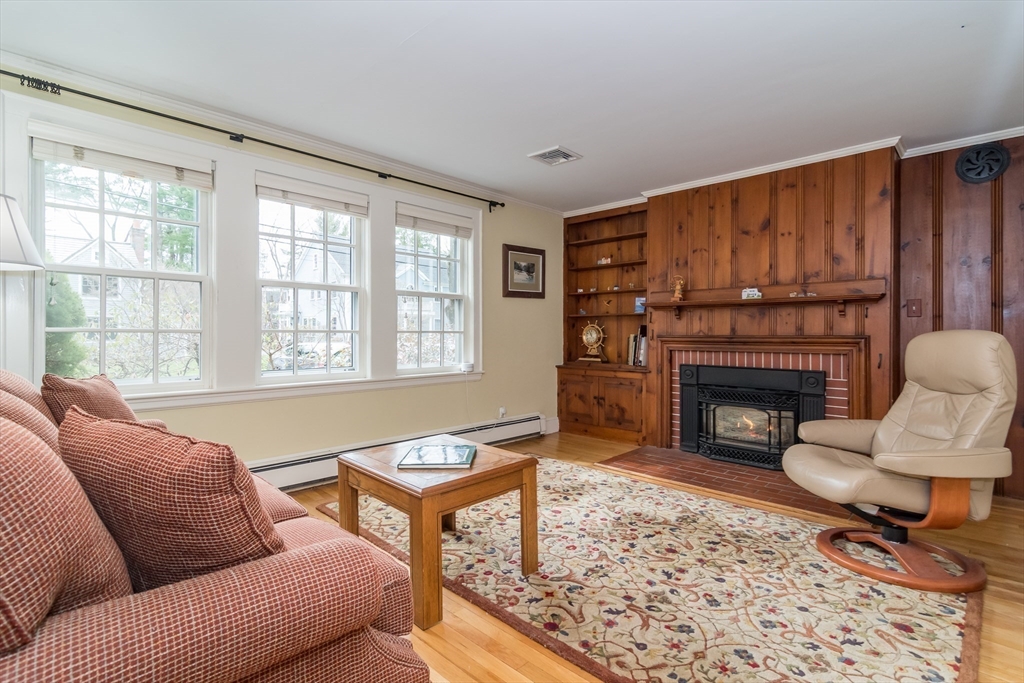 77 Parker Road Wellesley, MA 02482 - Photo 5 of 19 a living room with furniture a rug a fireplace and a large window