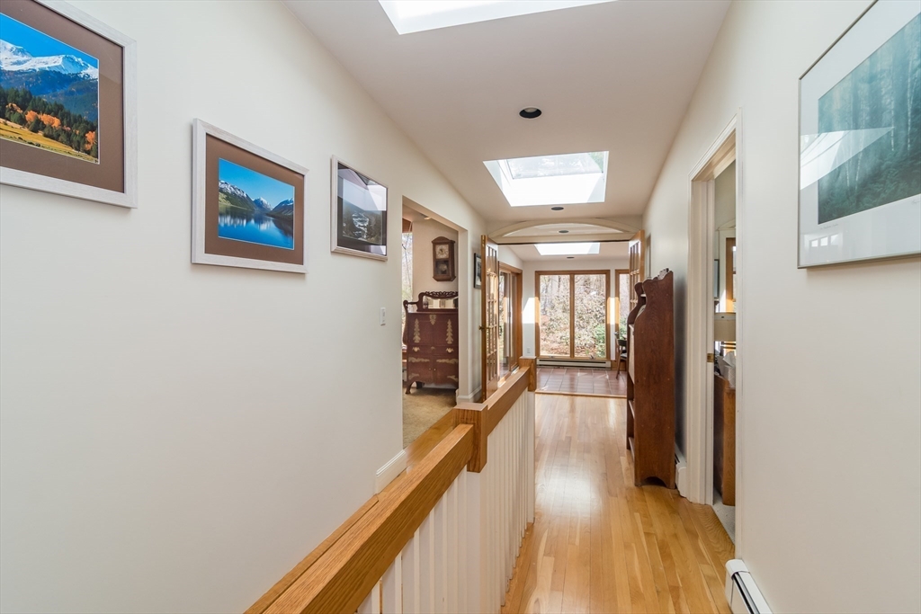 77 Parker Road Wellesley, MA 02482 - Photo 9 of 19 a view of a hallway with wooden floor and staircase