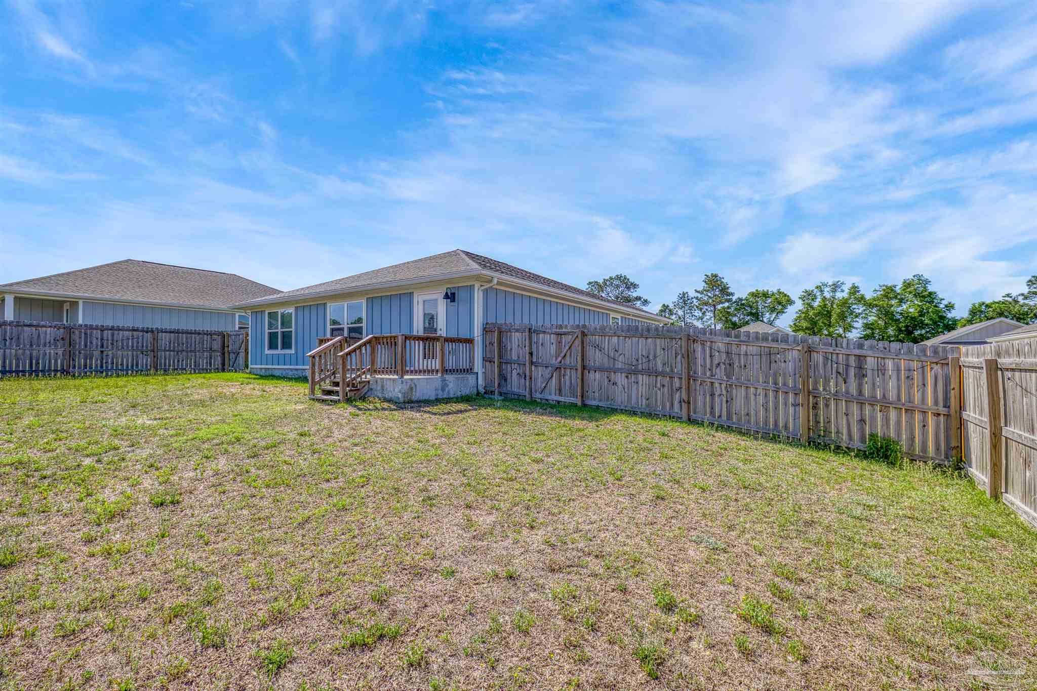 2665 Saltgrass Way Crestview, FL 32536 - Photo 12 of 22 a swimming pool with wooden fence