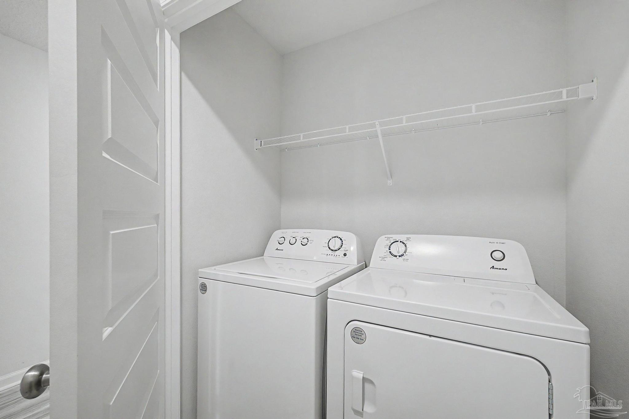 2665 Saltgrass Way Crestview, FL 32536 - Photo 18 of 22 a view of storage and utility room with washer and dryer