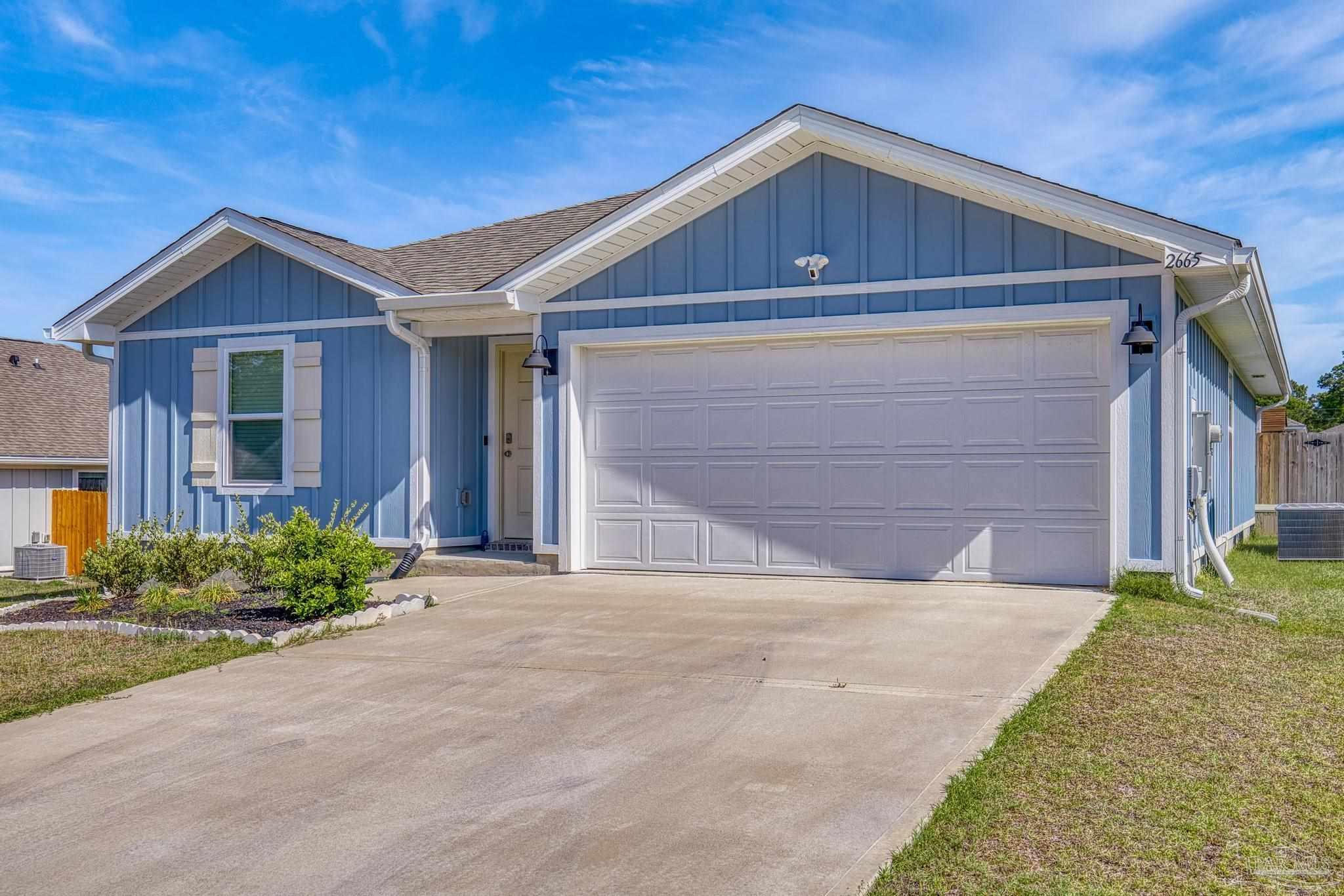 2665 Saltgrass Way Crestview, FL 32536 - Photo 2 of 22 a front view of house with yard and trees in the background