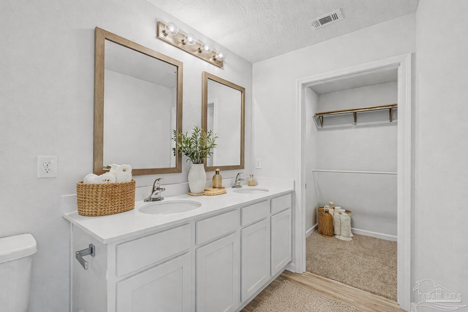 2665 Saltgrass Way Crestview, FL 32536 - Photo 5 of 22 a bathroom with a sink and a mirror