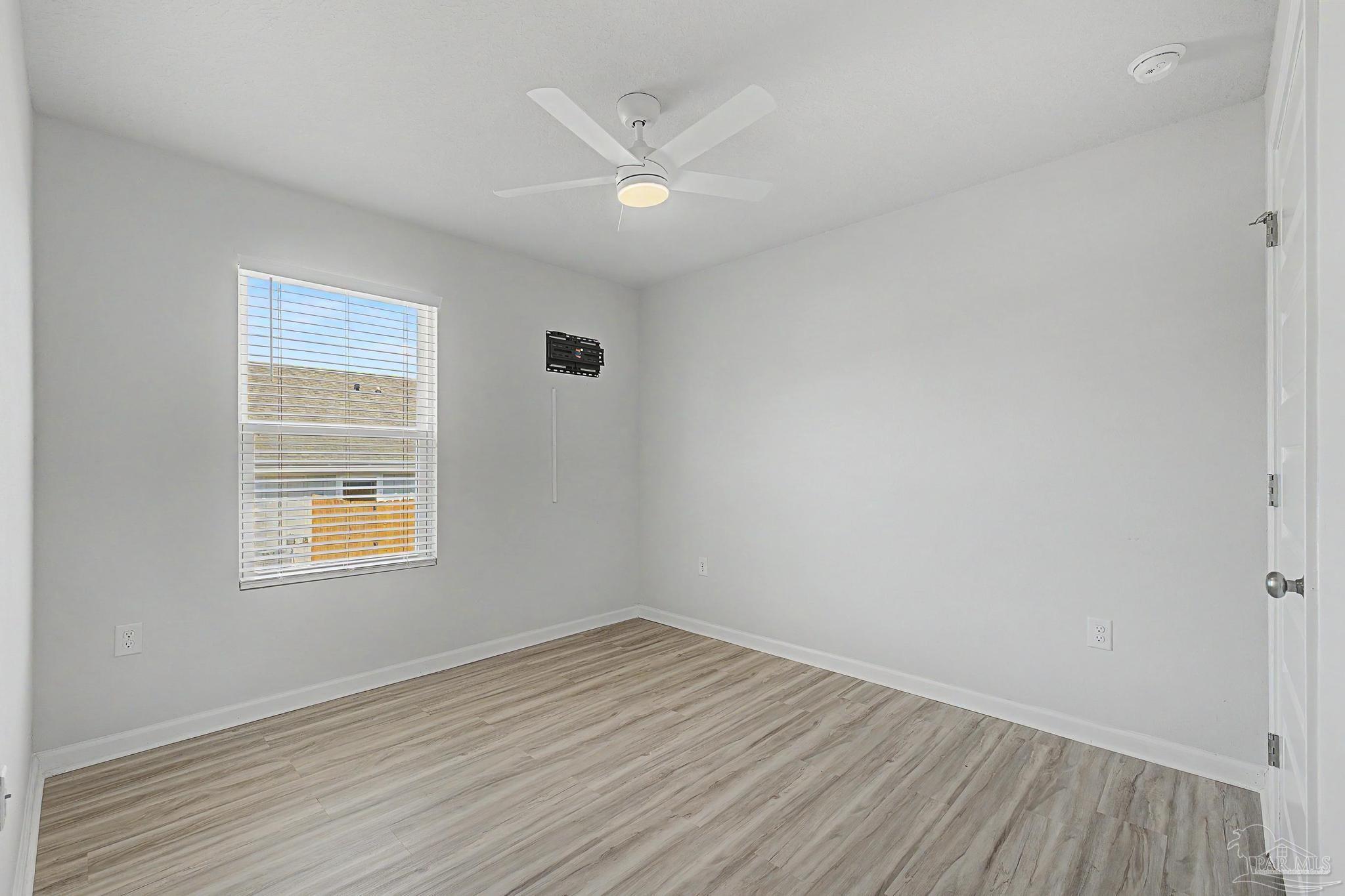 2665 Saltgrass Way Crestview, FL 32536 - Photo 10 of 22 wooden floor in an empty room with a window