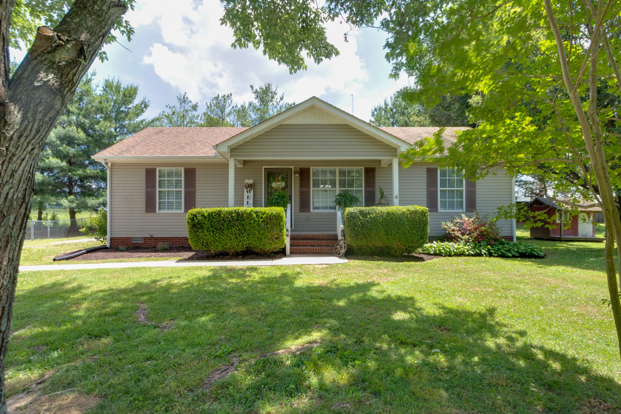 a front view of house with yard and green space