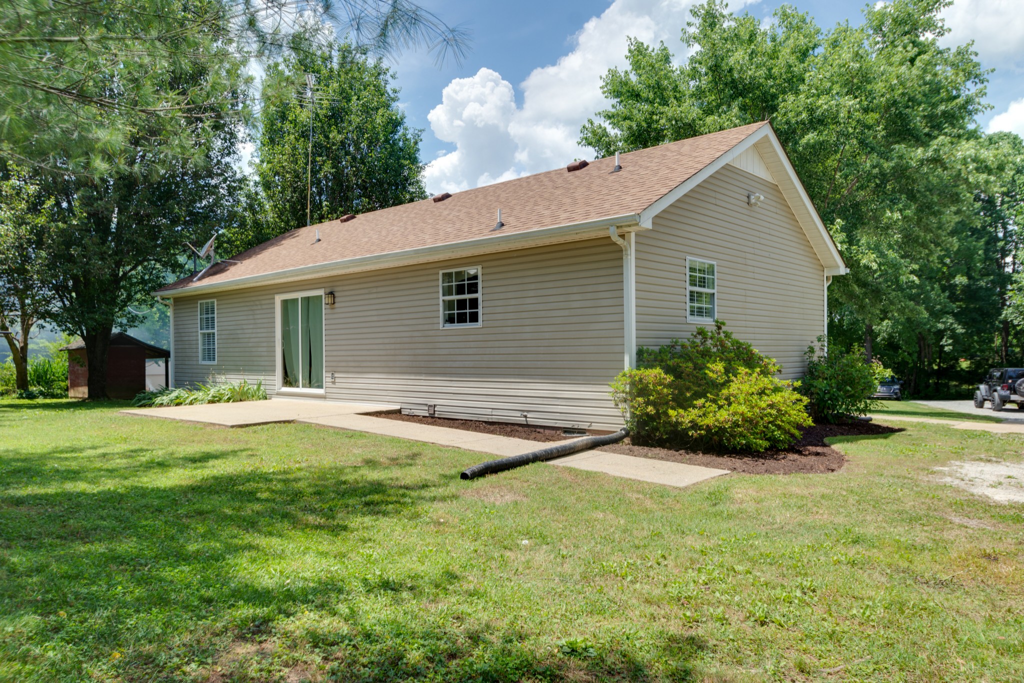 1345 Shores Road Goodspring, TN 38460 - Photo 16 of 21 a backyard of a house with flower garden