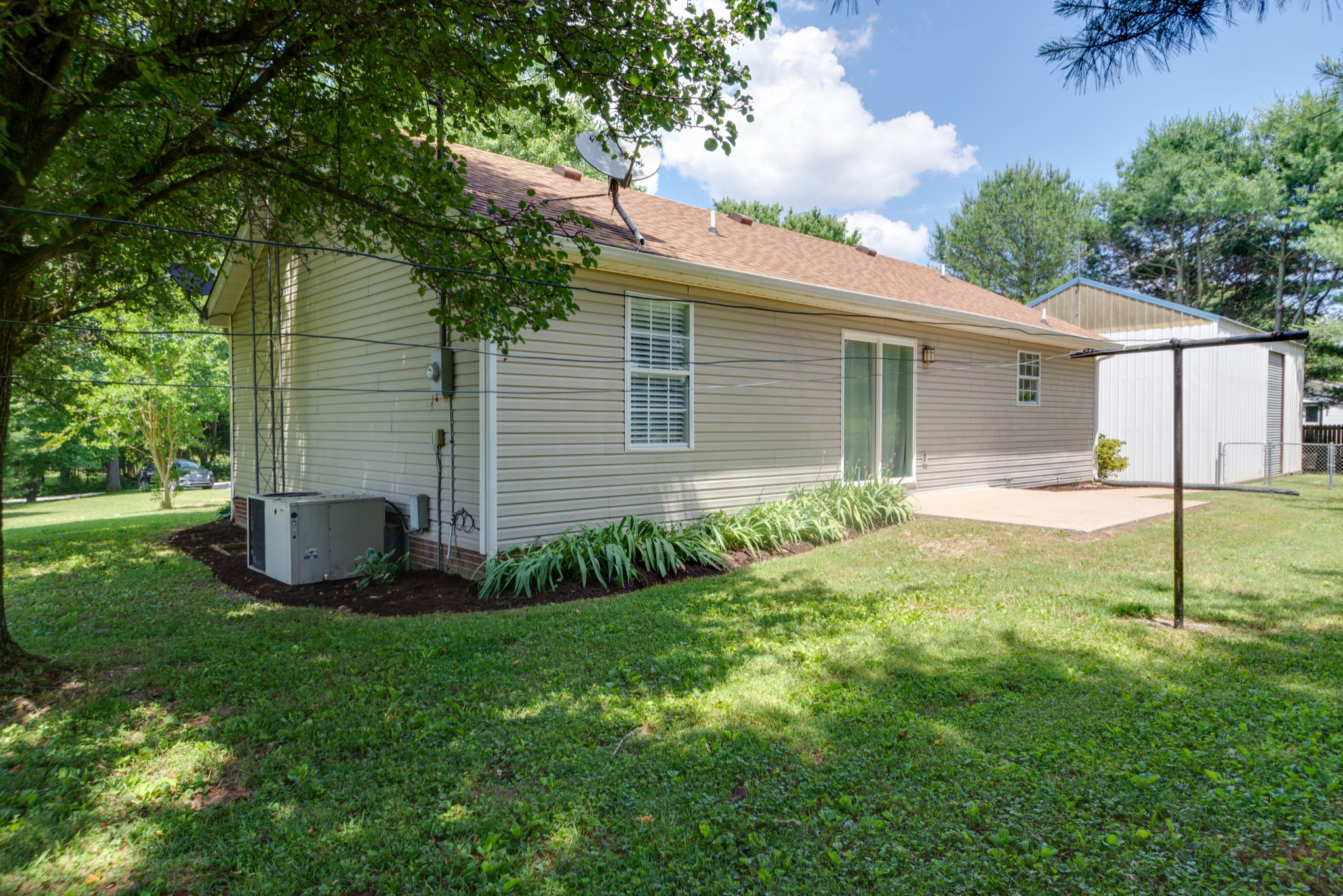 1345 Shores Road Goodspring, TN 38460 - Photo 17 of 21 a backyard of a house with plants and large tree