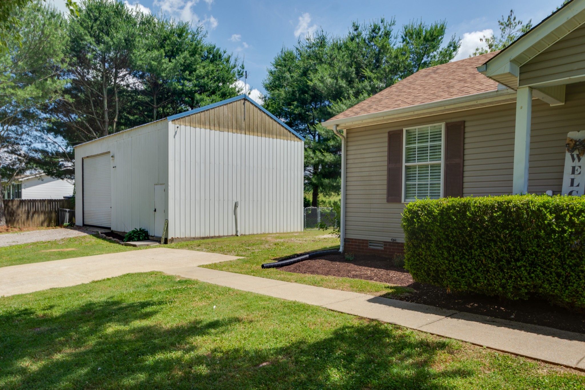 1345 Shores Road Goodspring, TN 38460 - Photo 18 of 21 a view of backyard of house with garage and plants