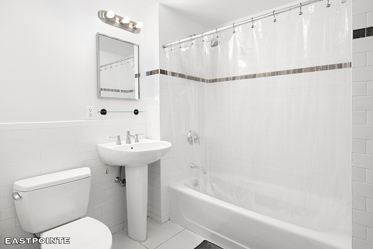 189 Avenue C, Unit 10D Manhattan, NY 10009 - Photo 4 of 10 a bathroom with a sink toilet and shower
