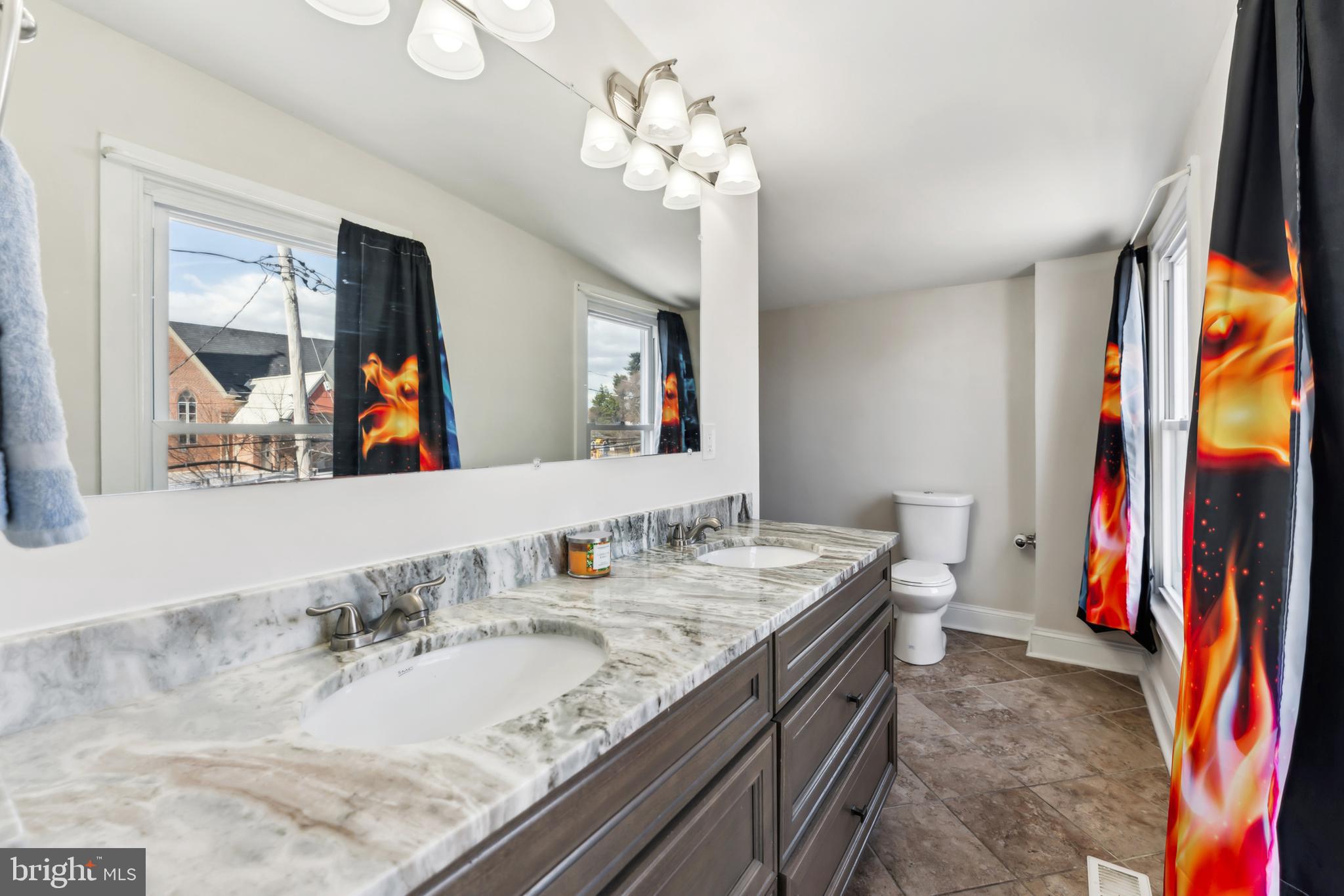 9 Carroll Street Westminster, MD 21157 - Photo 22 of 30 a bathroom with a granite countertop sink a large mirror and a shower