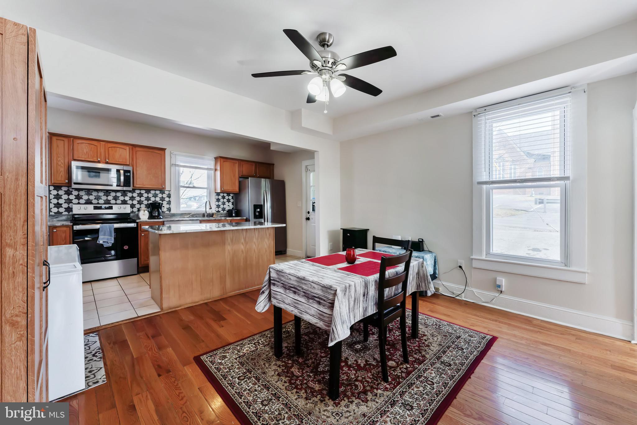 9 Carroll Street Westminster, MD 21157 - Photo 7 of 30 a kitchen with a table chairs refrigerator and cabinets