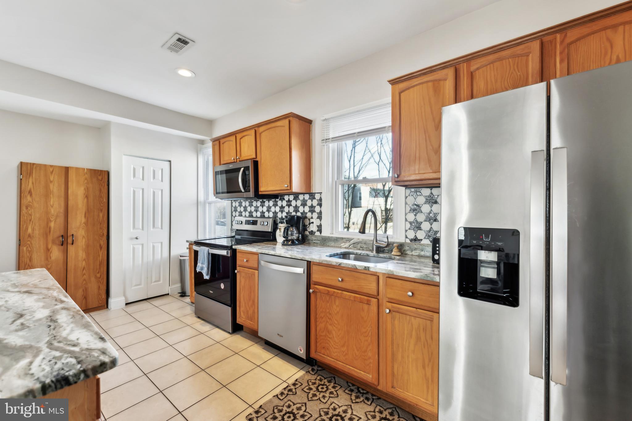 9 Carroll Street Westminster, MD 21157 - Photo 10 of 30 a kitchen with stainless steel appliances granite countertop a refrigerator and a stove top oven