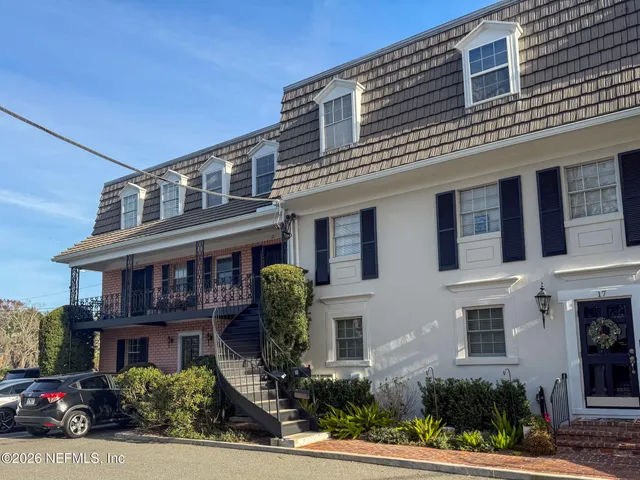 a front view of a residential apartment building with a yard