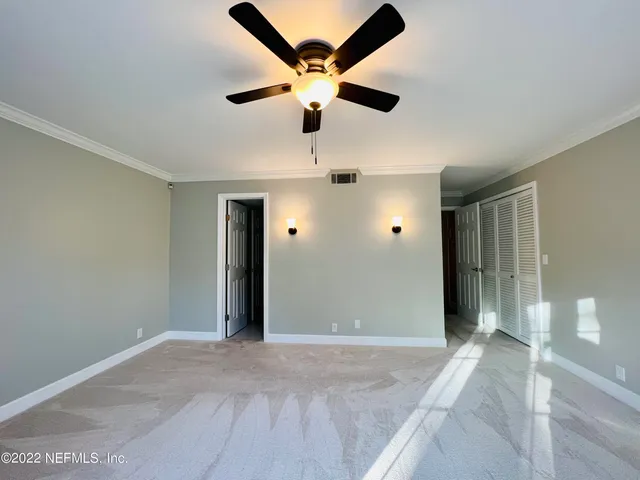 a view of a livingroom with a ceiling fan and window