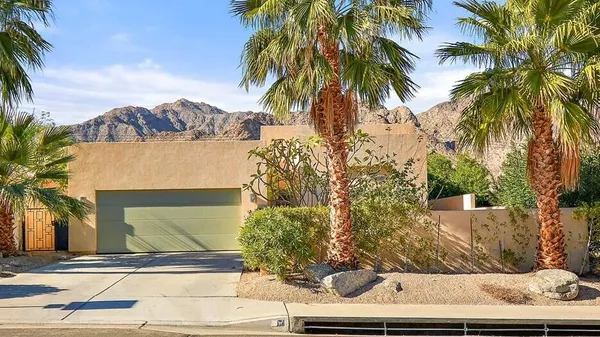 a view of a yard with palm trees