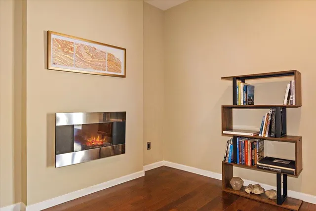 a view of a workspace with furniture and wooden floor